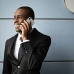 Mężczyzna w garniturze rozmawia przez telefon w nowoczesnym biurze